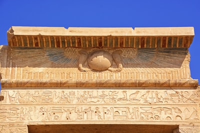 brown concrete wall with human face carved